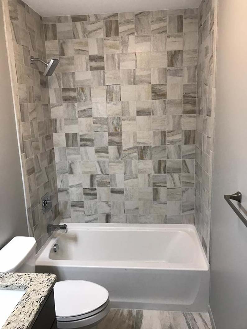 Tub with fancy tile back wall in bathroom bathroom designed by Weinstein Allentown Bath & Kitchen Design Services