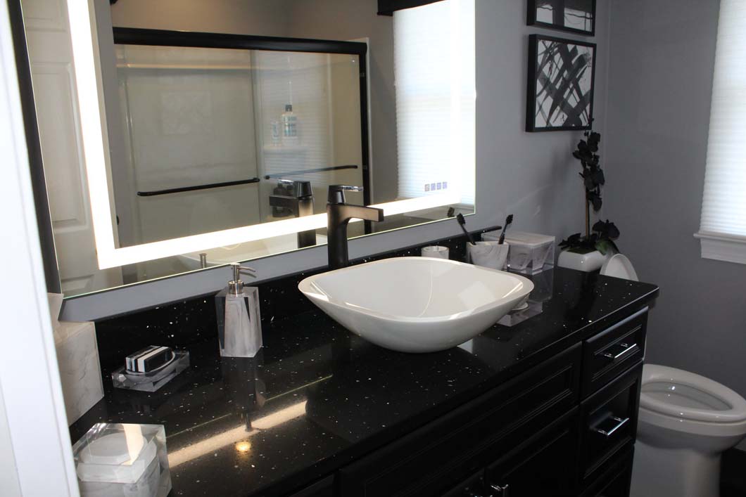 Black vanity and basin sink in bathroom designed by Weinstein Allentown Bath & Kitchen Design Services